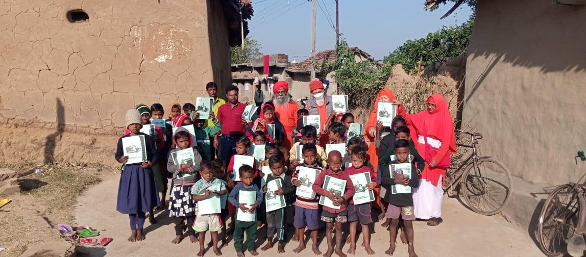 School children holding notebooks in rural surroundings