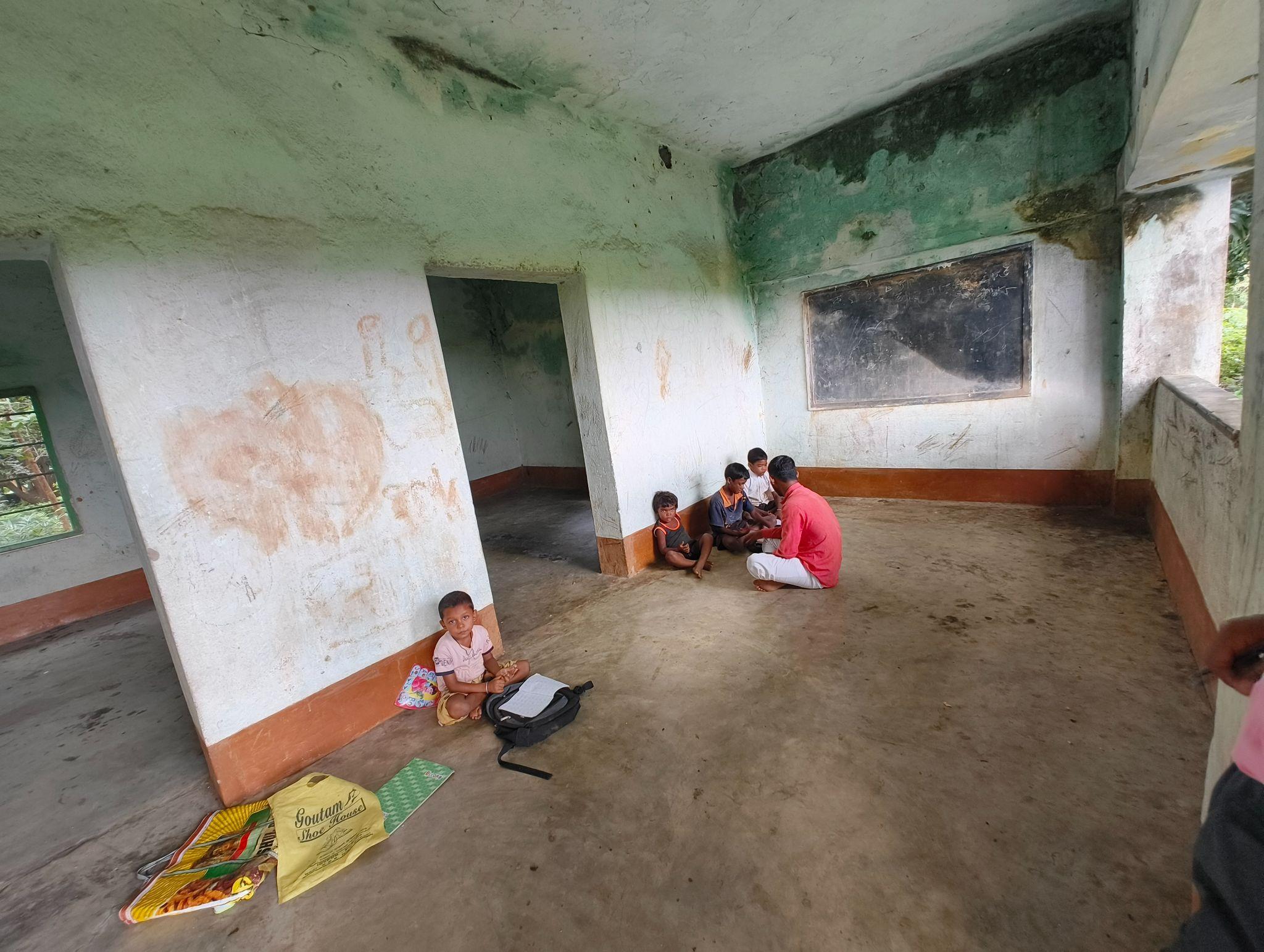 Young children standing in a row at rural school campus